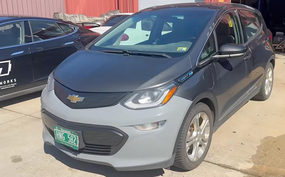 The gray Chevrolet Bolt EV with 471,616 miles outside the repair shop